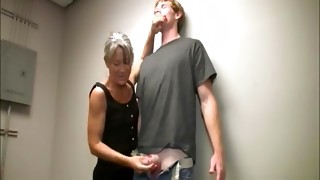 Mature woman in a dress gets a facial