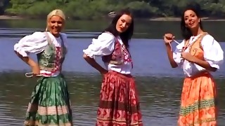 Seductive dolls with natural tits getting banged hardcore at the beach in a captivating group sex